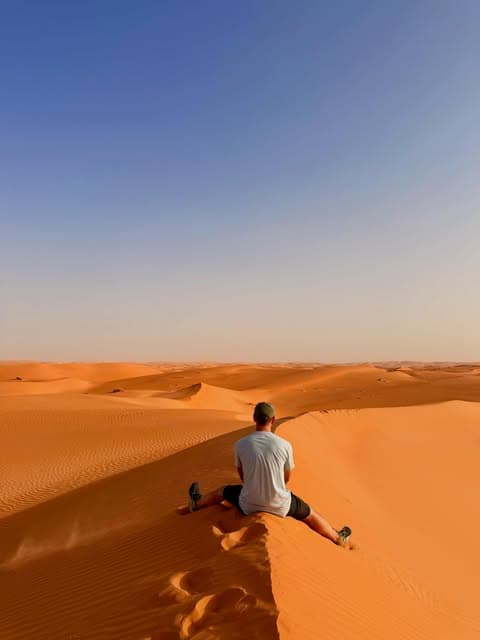 Emilio looking out across the golden dunes of the Sahara